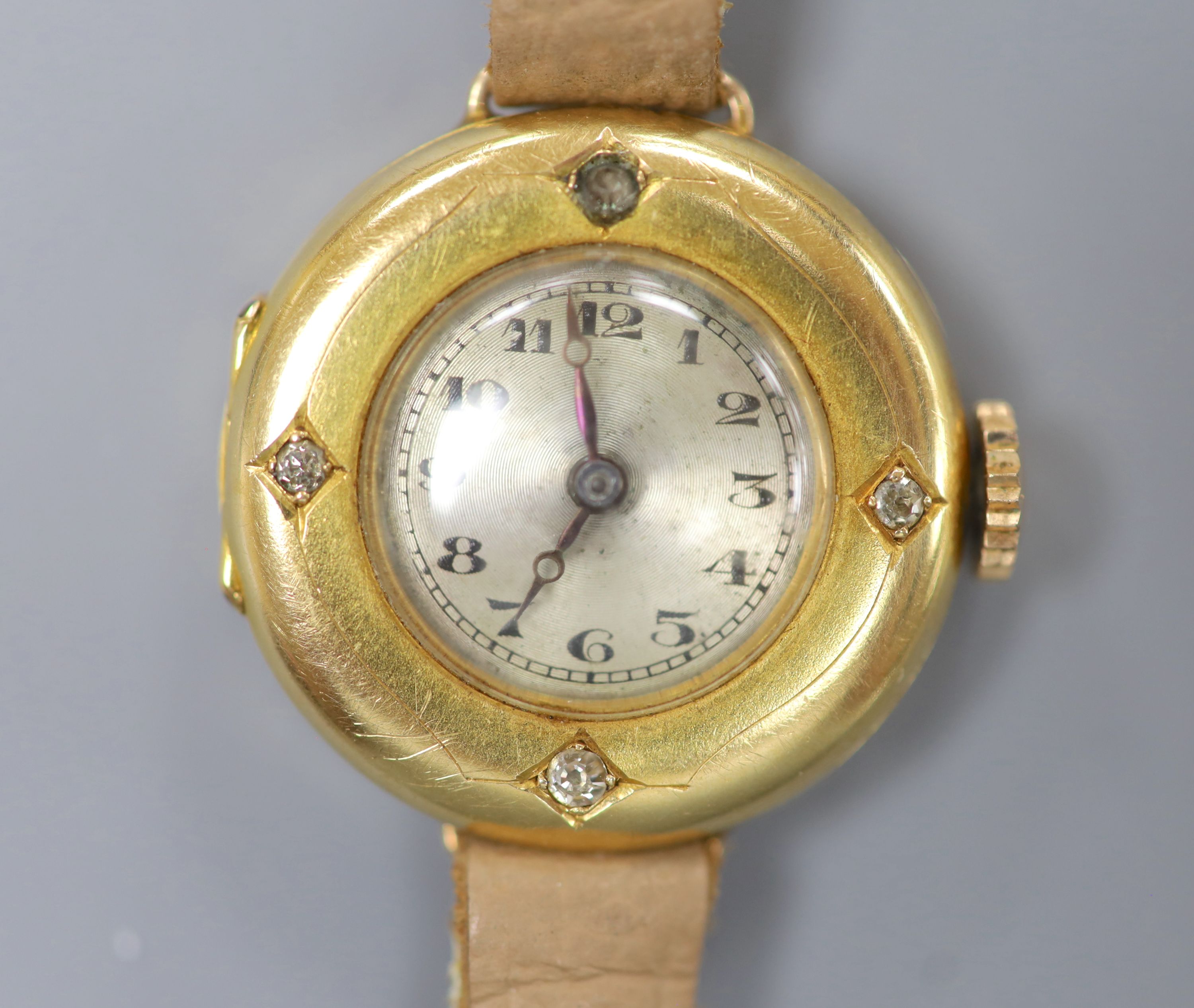 A lady's early to mid 20th century 18k yellow metal and diamond set manual wind wrist watch, on a leather strap